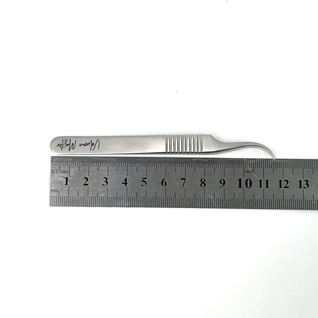 a Lash Tribe Volume Master | Curved Precision Tweezer with a ruler next to it.