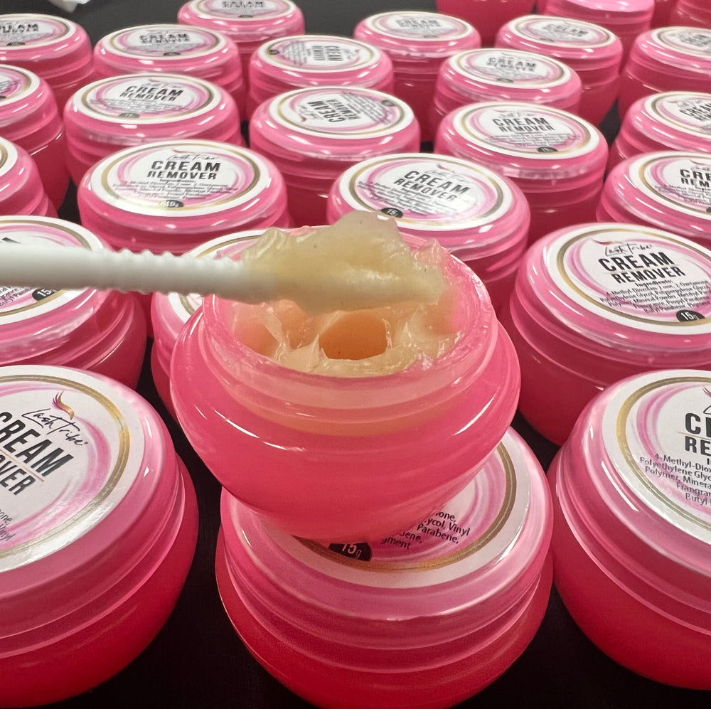 a bunch of Lash Tribe® Cream Remover jars with a spoon in them.