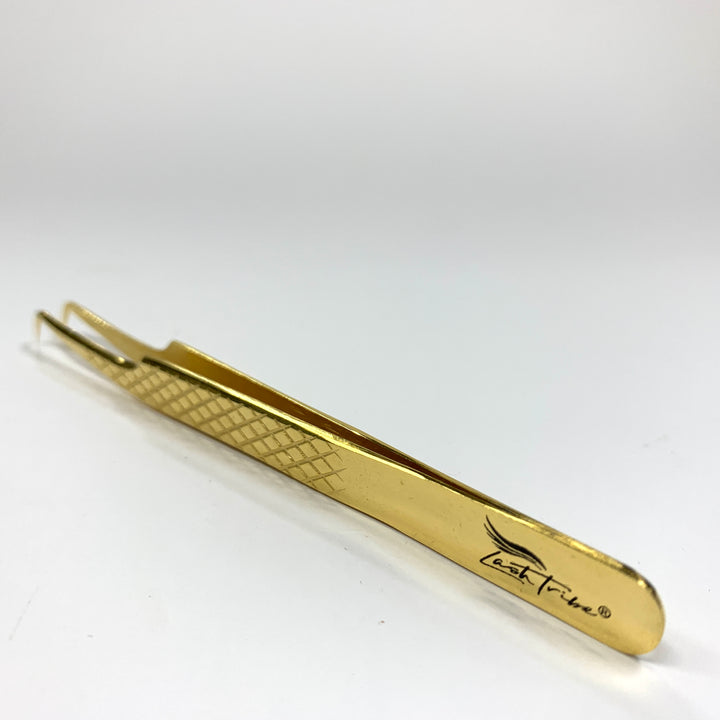 a Lash Tribe Diamond Russian Volume Tweezers on a white surface.