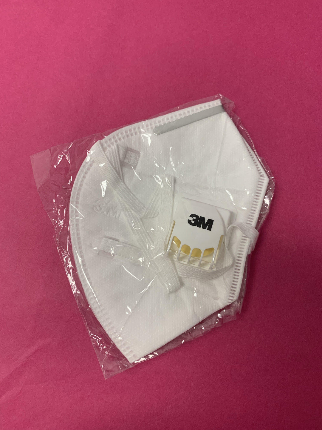 a Lash Tribe 3M KN95 Medical Grade Mask with Valve sitting on a pink background.