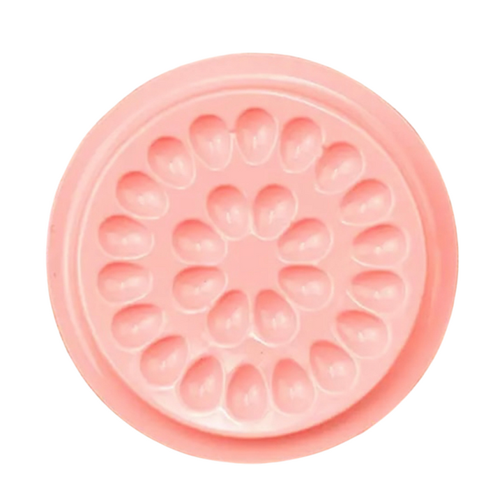 A Lash Tribe pink flower shaped mold on a white background.