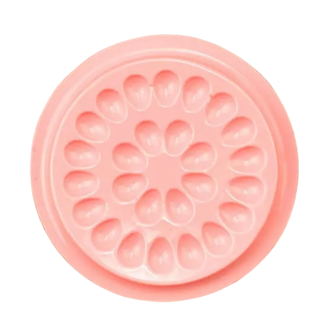 A Lash Tribe pink flower shaped mold on a white background.
